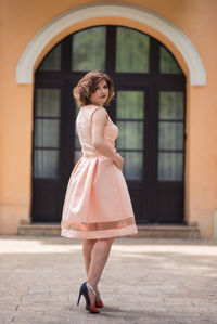 Full length portrait of woman standing outdoors