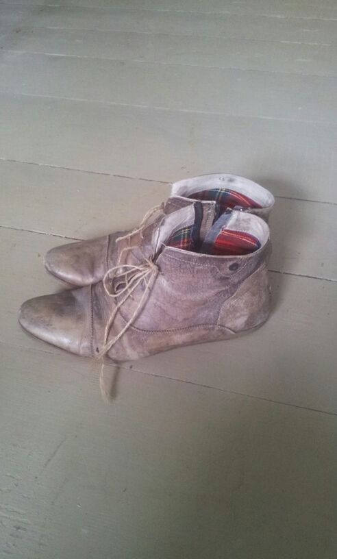 high angle view, indoors, shoe, close-up, day, one animal, abandoned, no people, wall - building feature, animal themes, still life, sunglasses, reflection, pair, flooring, footwear, single object, damaged, sunlight