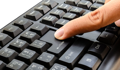 Close-up of hand using laptop