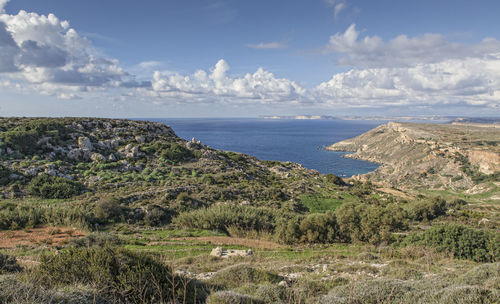 Scenic view of sea and landscape against sky