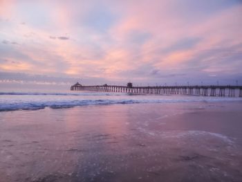 Scenic view of beach against sky during sunset