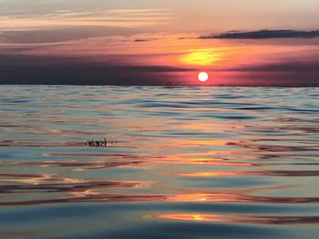 Scenic view of sea against romantic sky at sunset