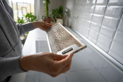 Cropped hand using mobile phone