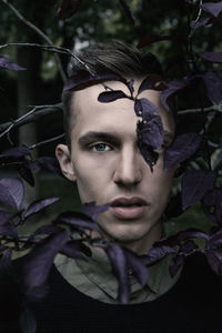 Portrait of man amidst purple leaves