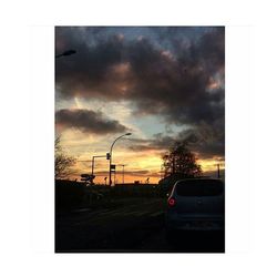 Road against cloudy sky at sunset