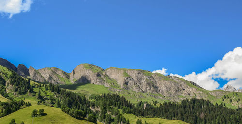 Scenic view of mountains against blue sky