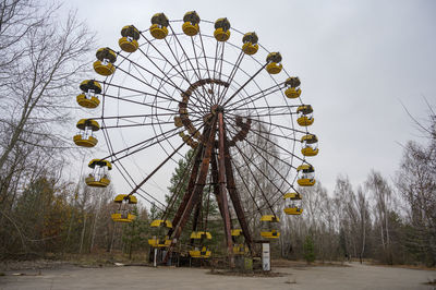 Low angle view of ferris wheel against sky