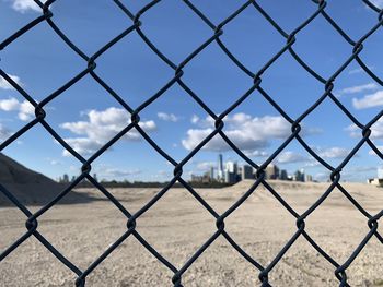 Full frame shot of chainlink fence against sky