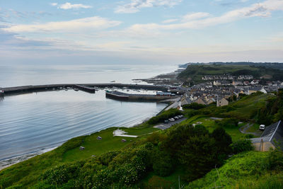 Scenic view of sea by city against sky