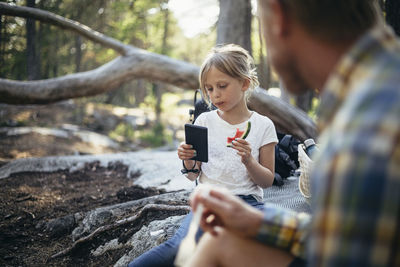 Full length of woman using mobile phone outdoors