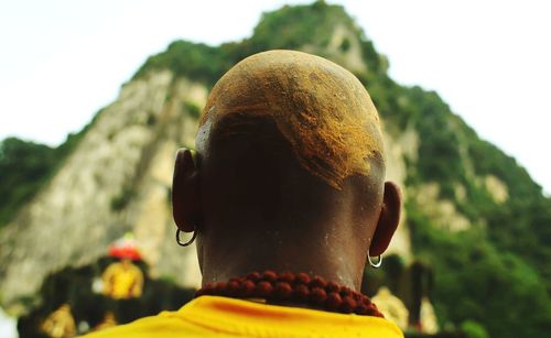 Rear view portrait of man against blurred background