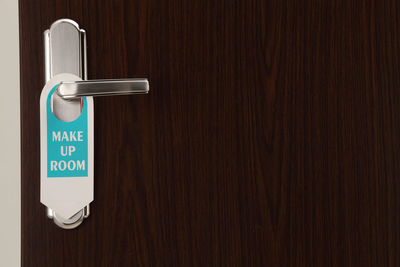 Close-up of information sign on doorknob