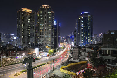 High angle view of illuminated buildings against sky at night