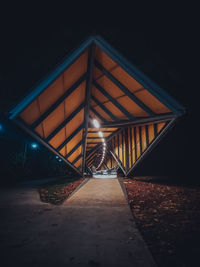 Illuminated bridge against sky at night