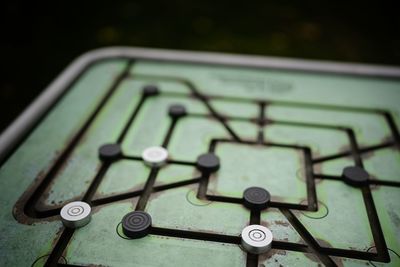 Metal outdoors checker's game with black and white opponents 