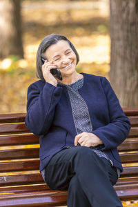 Smiling young man sitting in park