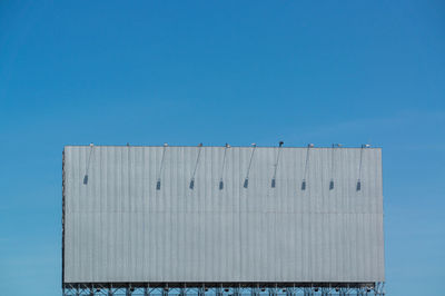 Low angle view of building against clear blue sky