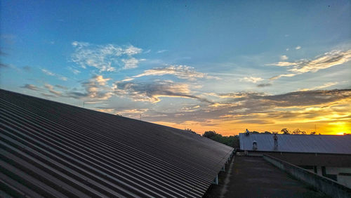 Scenic view of building against sky during sunset