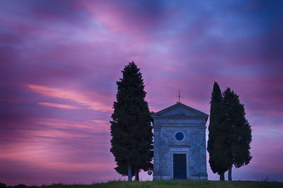 Low angle view  on capella di vitaleta of purple against sky at sunrise