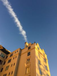 Low angle view of buildings against blue sky