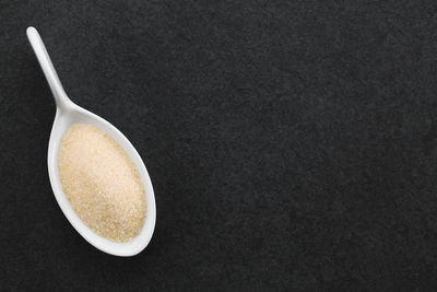 High angle view of coffee cup against black background