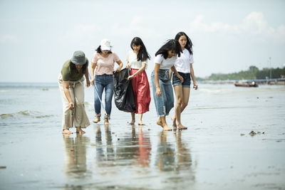 Group of people walking on beach