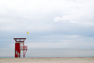 Lifeguard hut on beach against sky