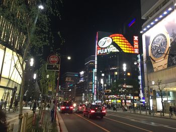 Illuminated city street at night