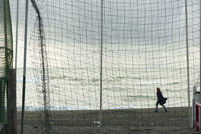 Side view of a man walking against the sky