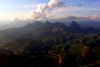 Scenic view of mountains against cloudy sky