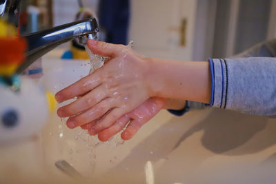 Close-up of kid washing hands 