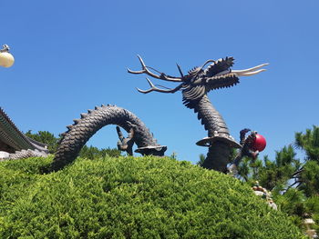 Low angle view of horse against clear blue sky