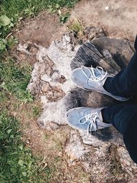 Low section of person standing on tiled floor