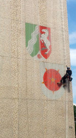 Low angle view of man with text against sky in city