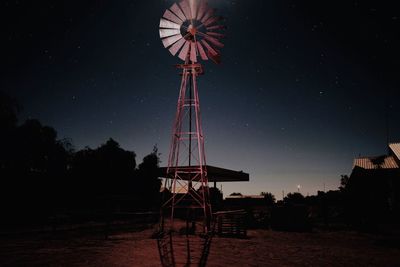 Low angle view of american style windmill on land against sky at night