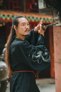 Portrait of young woman using mobile phone