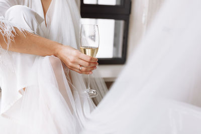 Midsection of bride holding bouquet