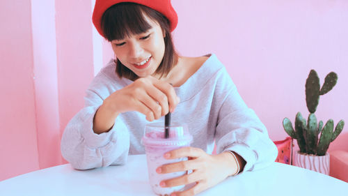 Young woman with drink at table