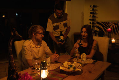 Young man and woman sitting at table