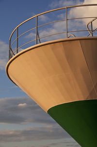 Low angle view of ship against cloudy sky during sunset