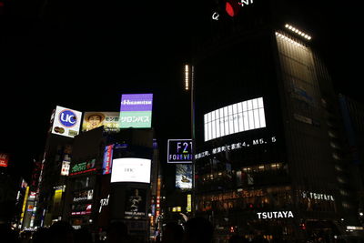 Illuminated city against sky at night