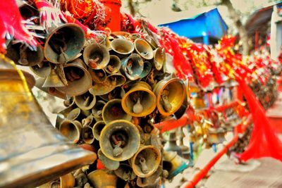 Close-up of bells tied on railing at temple