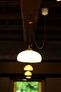 Low angle view of light bulb hanging from ceiling