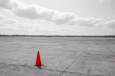 Airplane on runway against sky