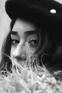 Close-up portrait of young woman with eye make-up