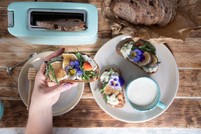 Delicious bruschetta with homemade bread, garnished with fig,soft cheese,pansies