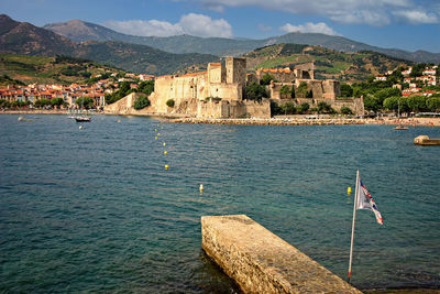 Scenic view of sea and buildings against sky