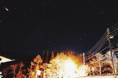 Low angle view of illuminated fireworks against sky at night