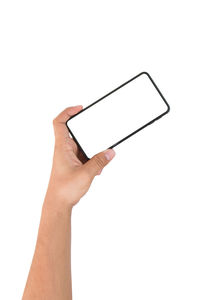 Close-up of hand holding smart phone against white background