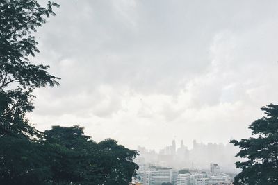 Low angle view of buildings against cloudy sky